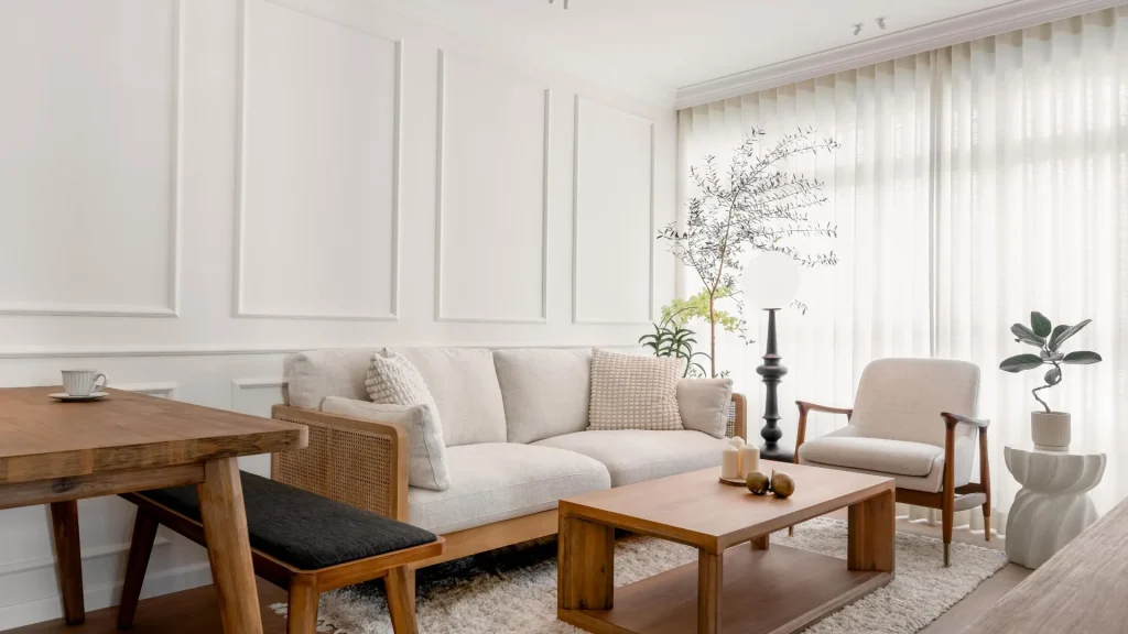 Warm 5 room HDB living room with wainscoting walls and natural timber furniture