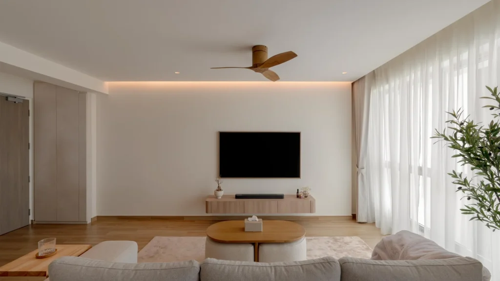 Warm minimalist living room with timber accents, cove lighting, and greenery by 6AM Spaces
