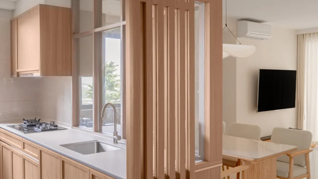 Open-plan kitchen with timber slatted partition connecting to dining area by 6AM Spaces