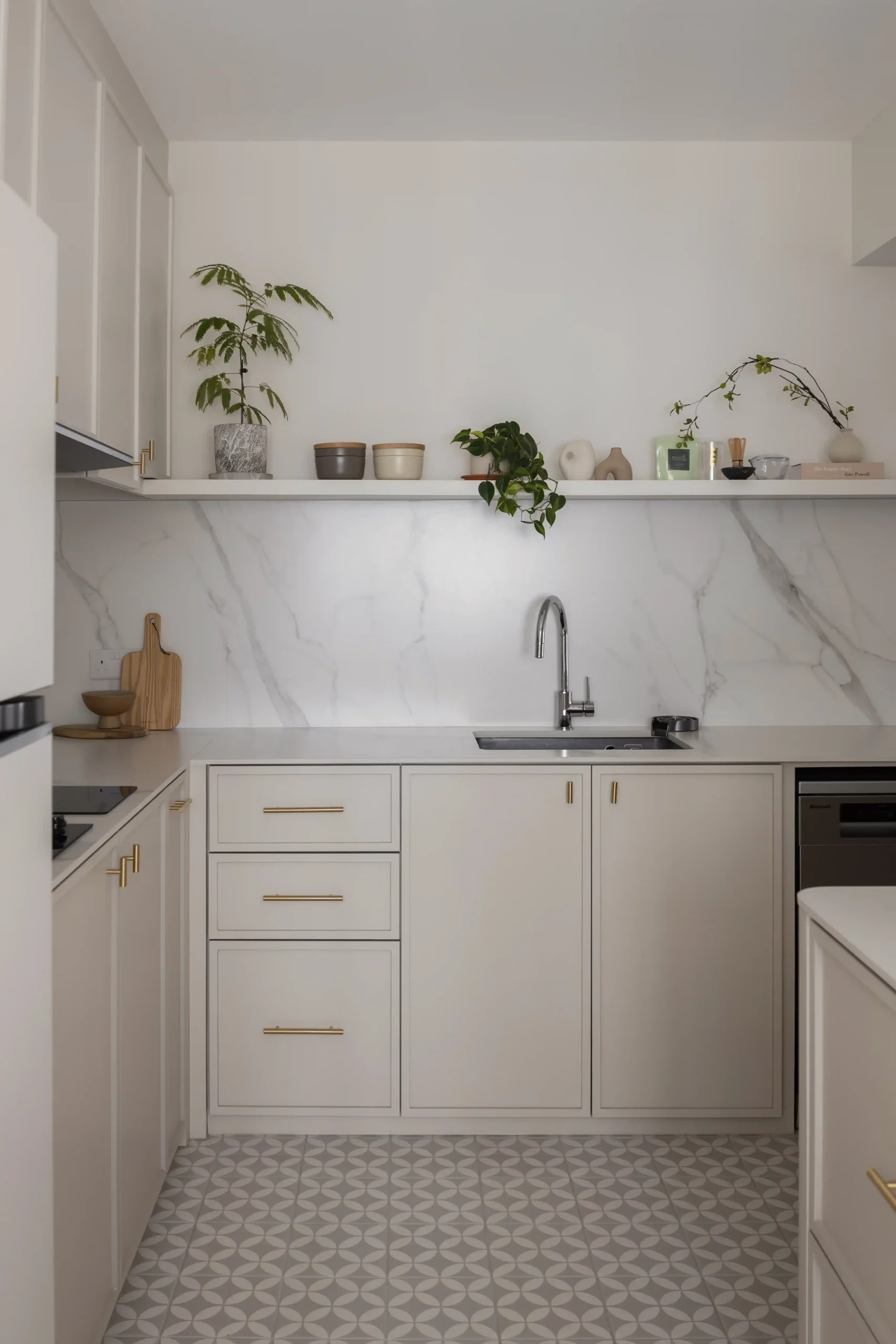 Minimalist Japanese-style kitchen sink counter with geometric patterned floor tiles.