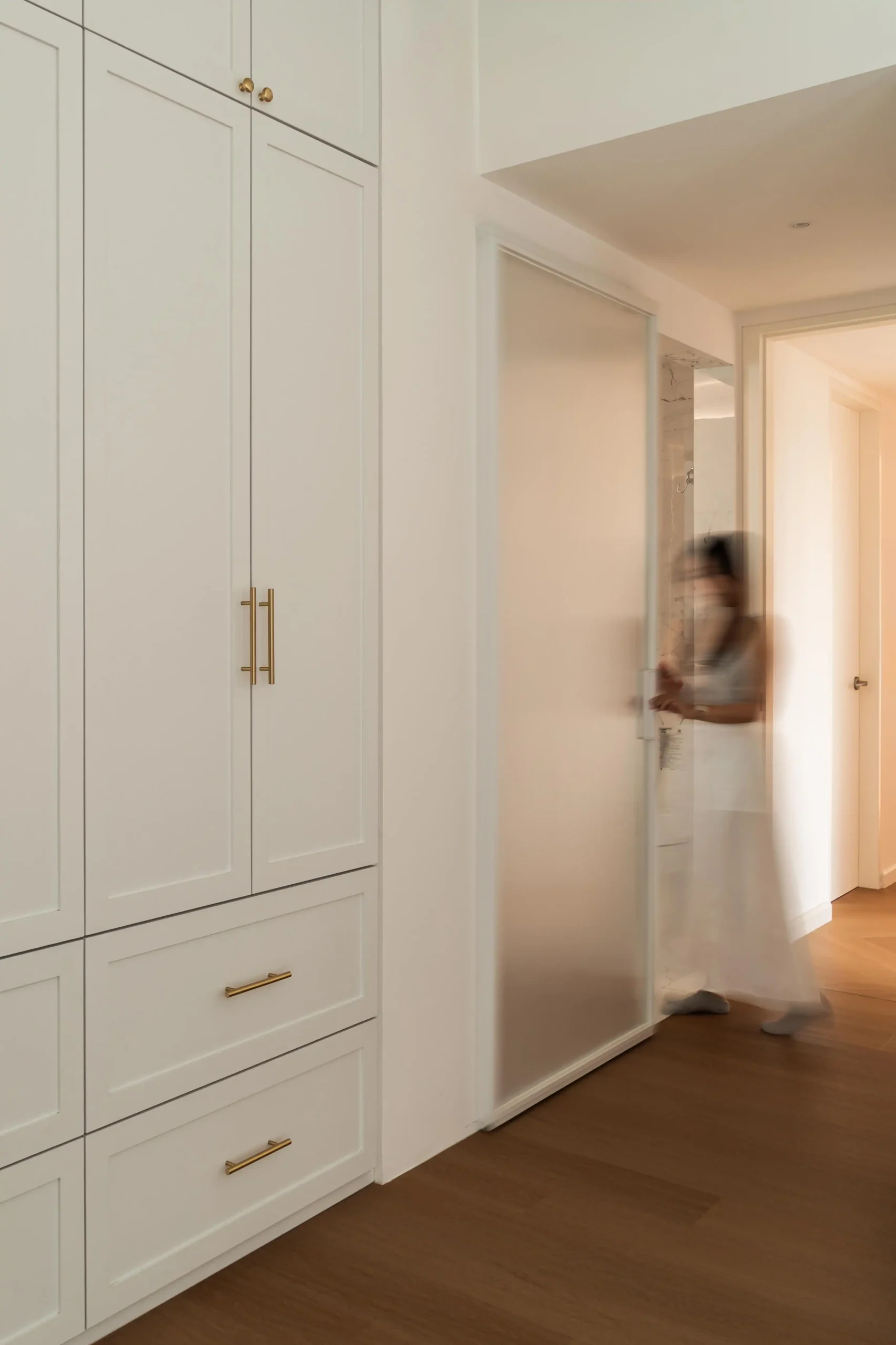 Modern Parisian bedroom cabinets with floor-to-ceiling integrated storage and seamless design