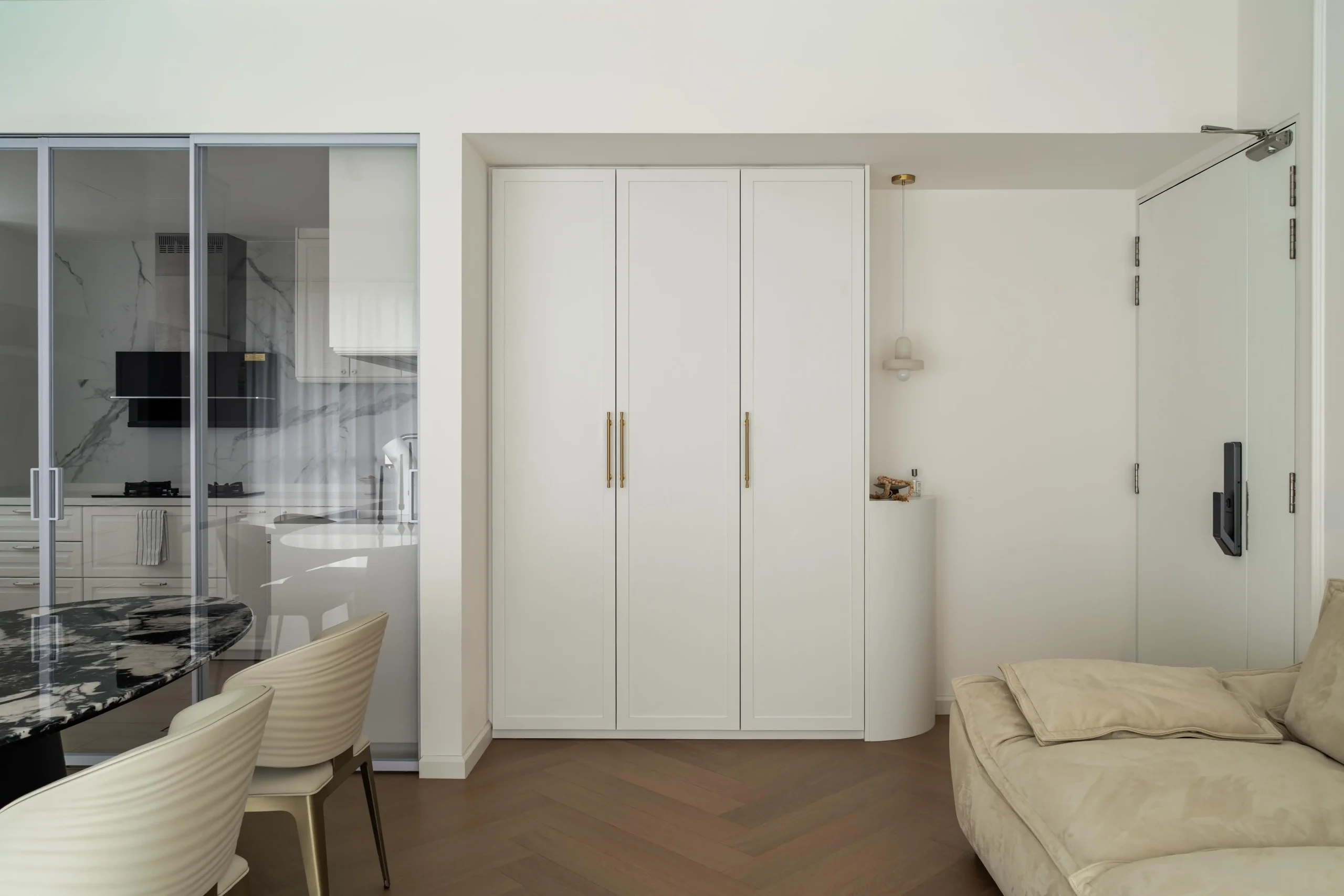 Living room featuring herringbone flooring and soft neutral tones