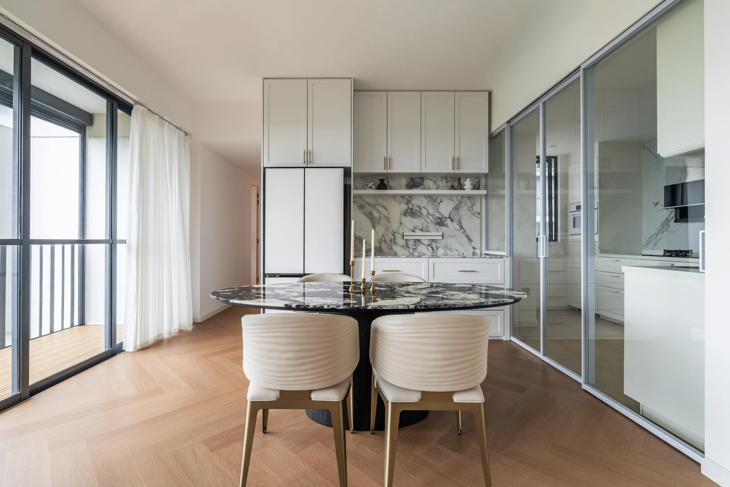 Modern Parisian dining area with marble table and elegant brass accents