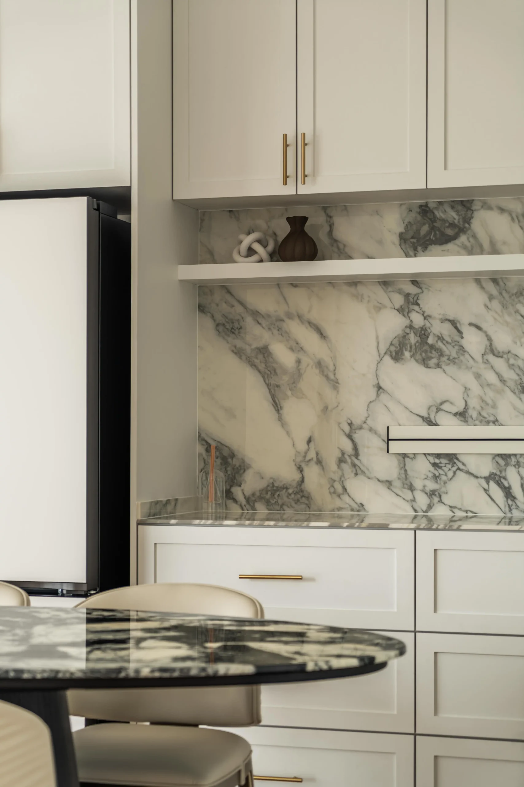 Built-in dining cabinet with marble detailing in a Modern Parisian interior with sleek storage design