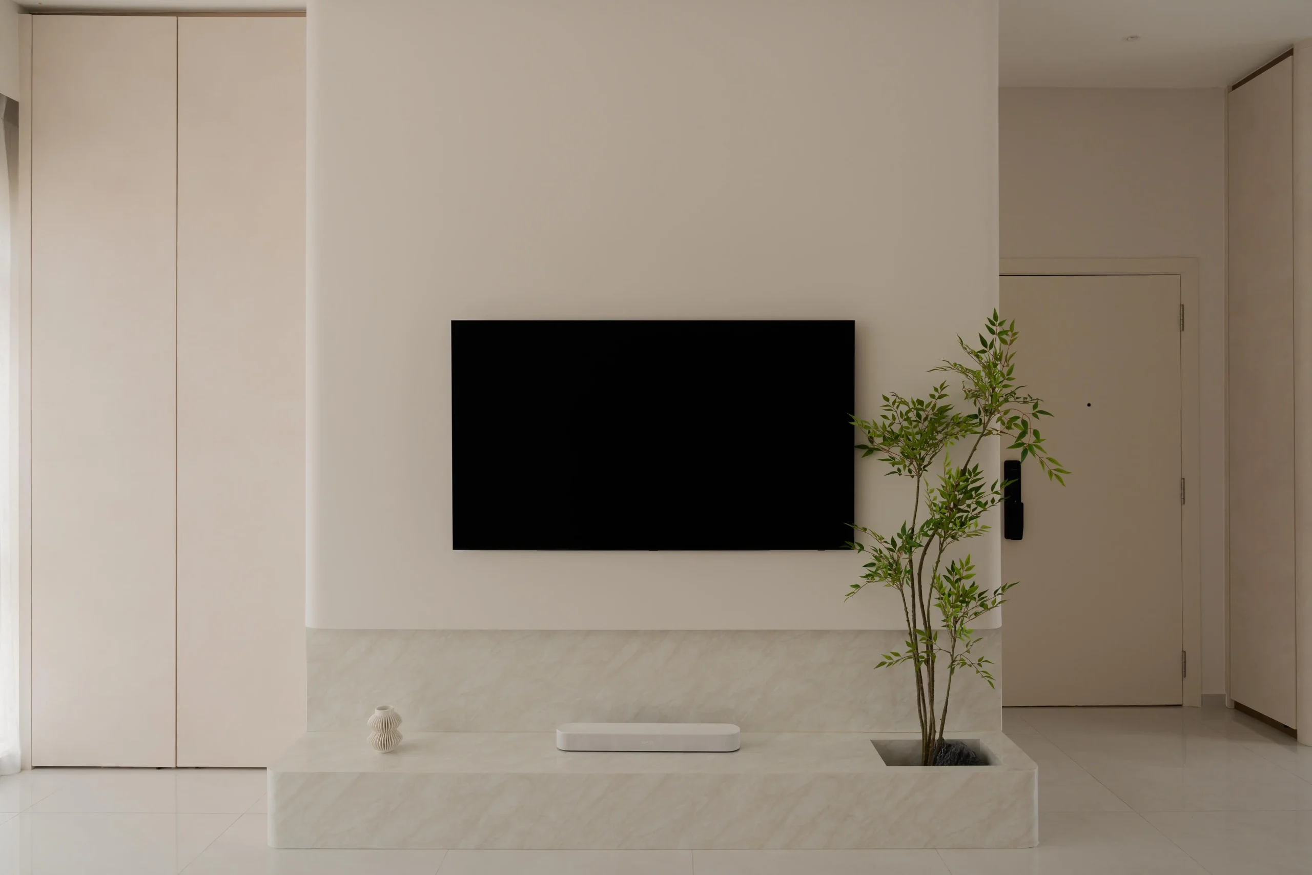 Minimalist living space featuring a streamlined TV console and clutter-free design
