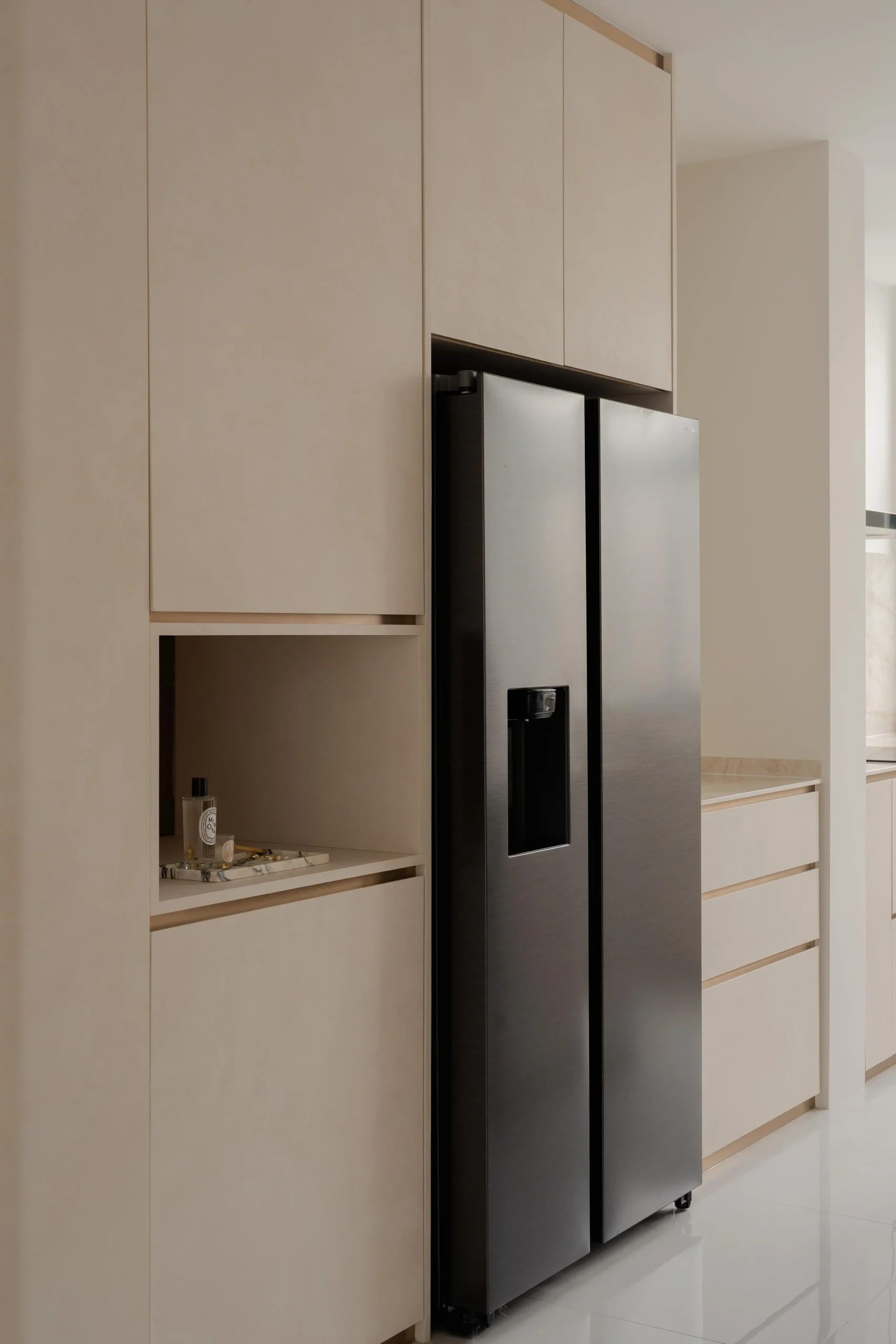 Minimalist kitchen interior with integrated refrigerator and clean, seamless cabinetry design
