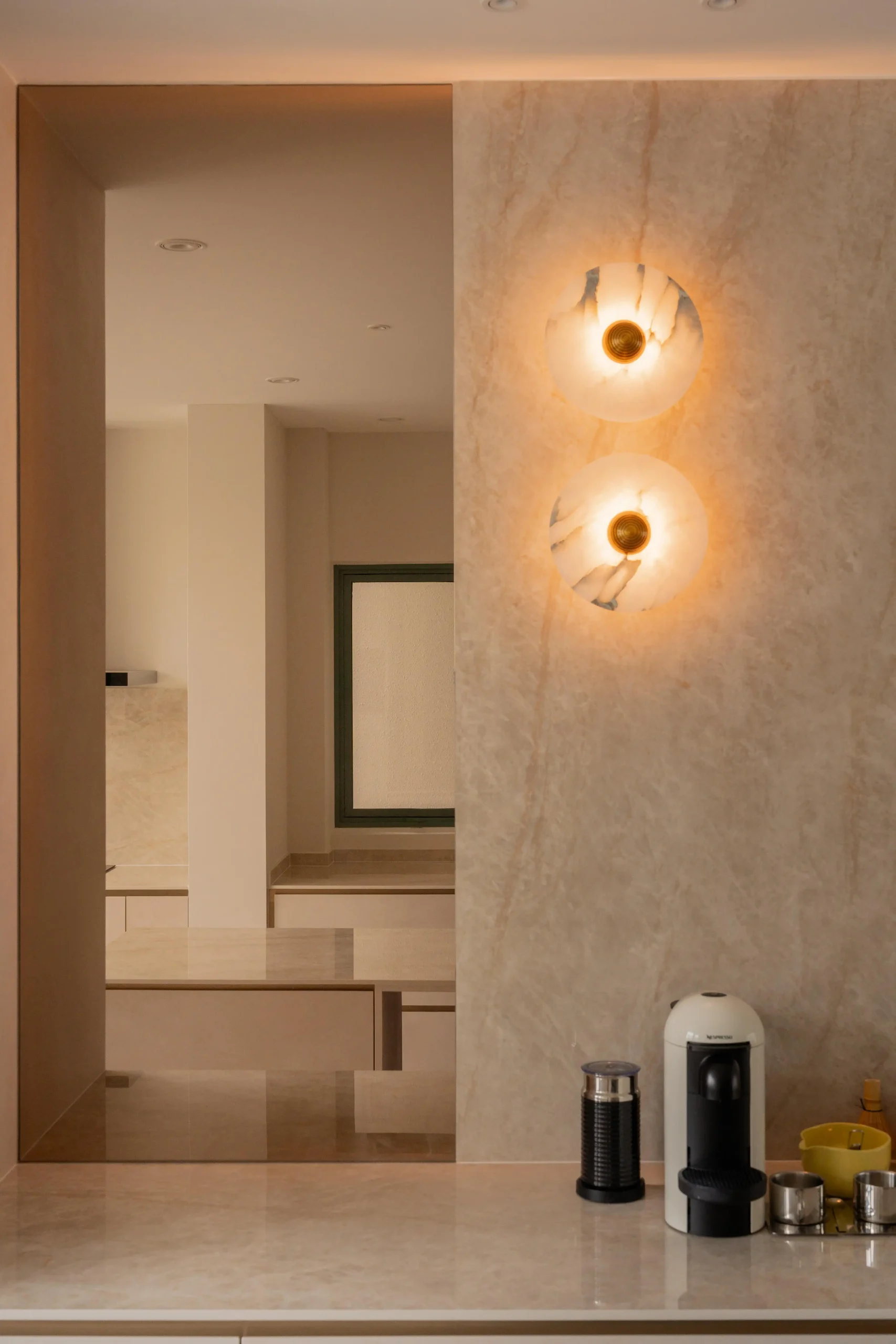 Minimalist coffee station with warm lighting and clean modern finishes