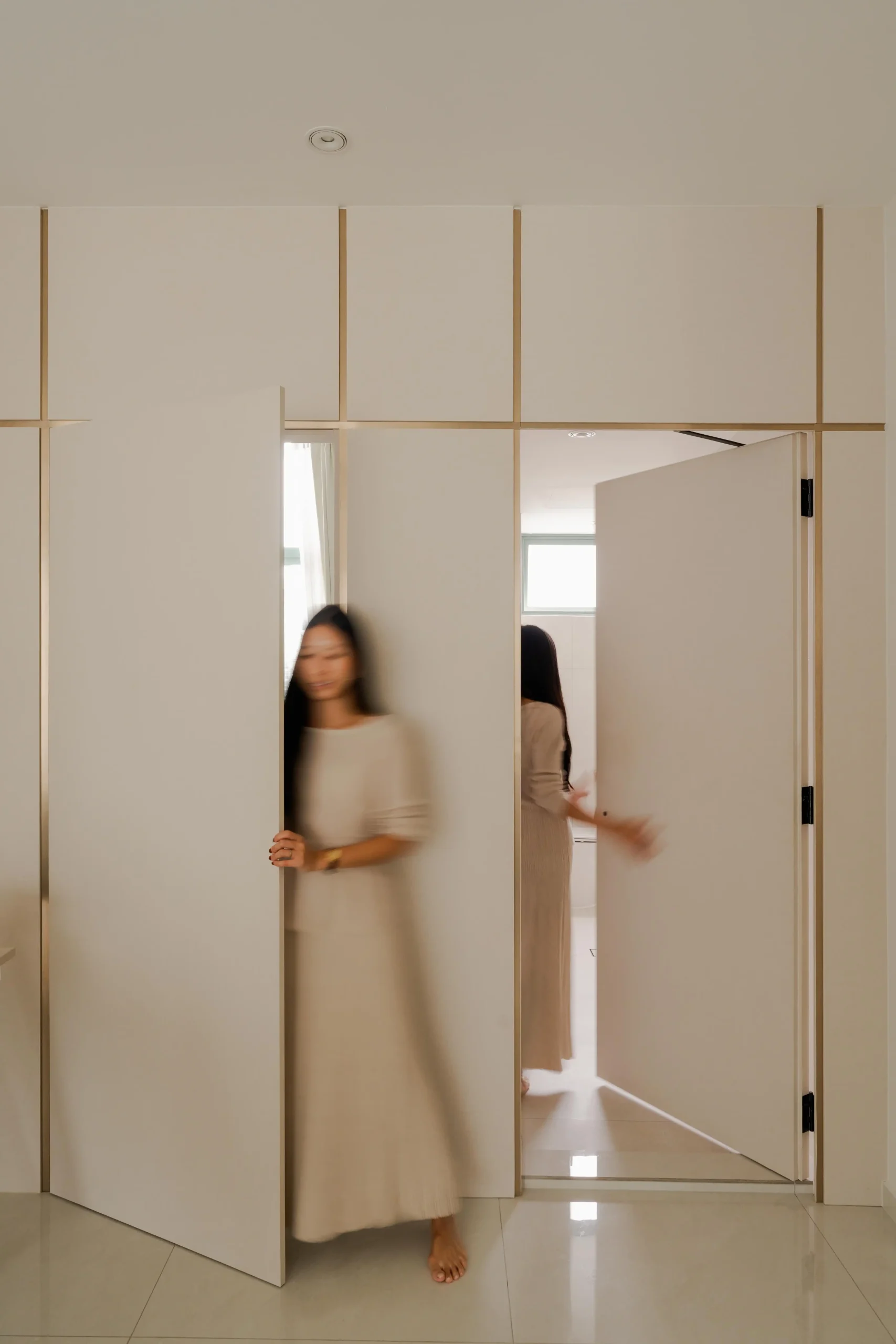 Minimalist interior featuring concealed seamless door integrated into wall paneling