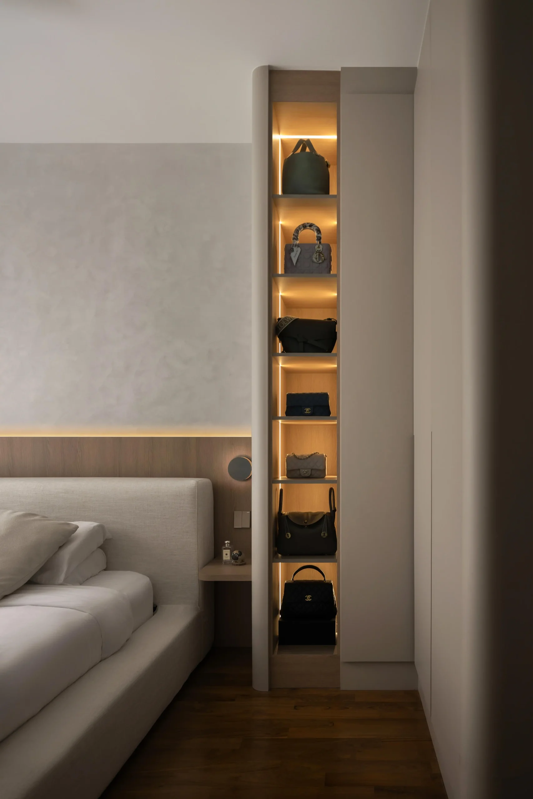 Built-in bedroom wardrobe with backlit handbag display shelves in modern japandi style