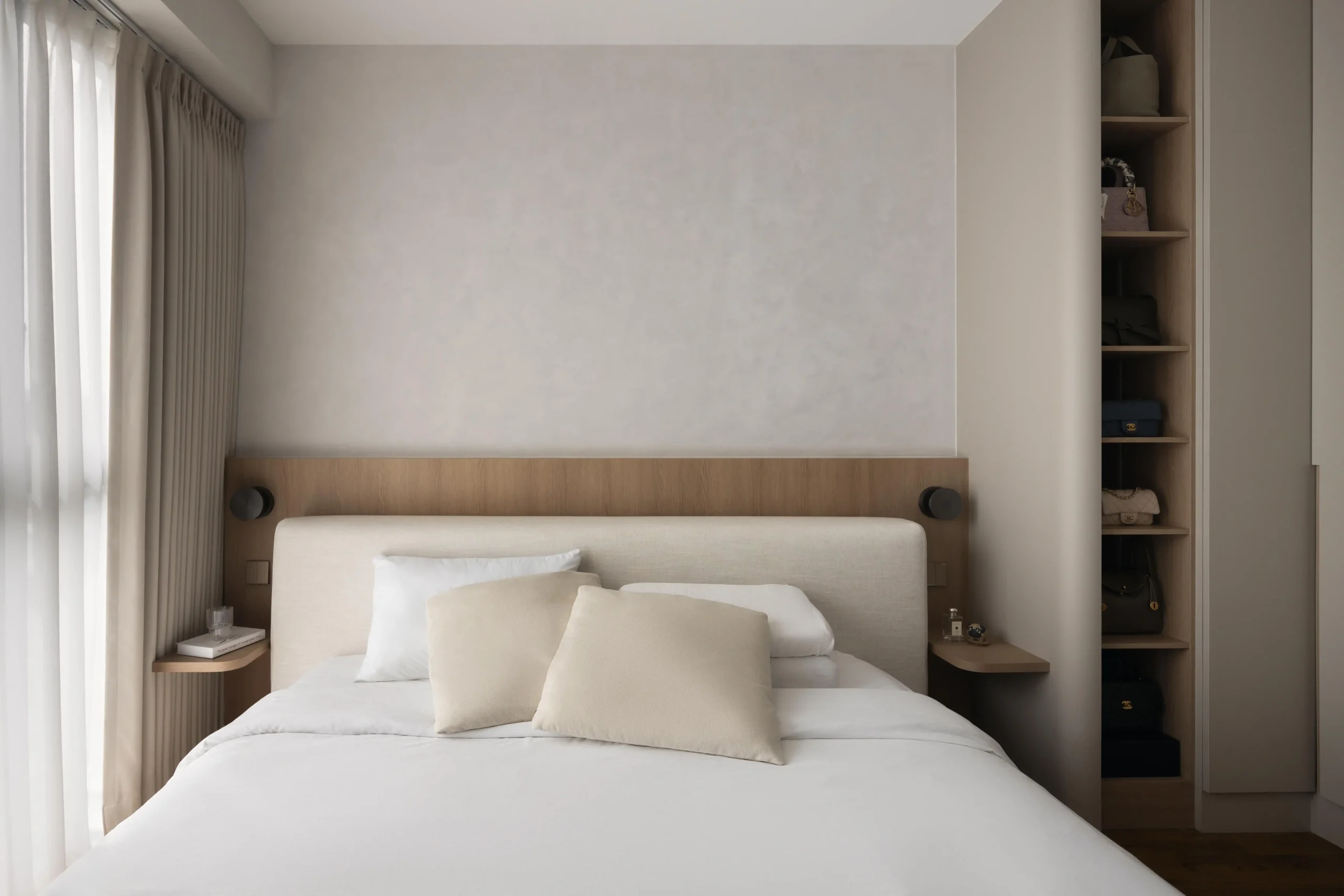 Centered view of a minimalist bed and integrated wardrobe