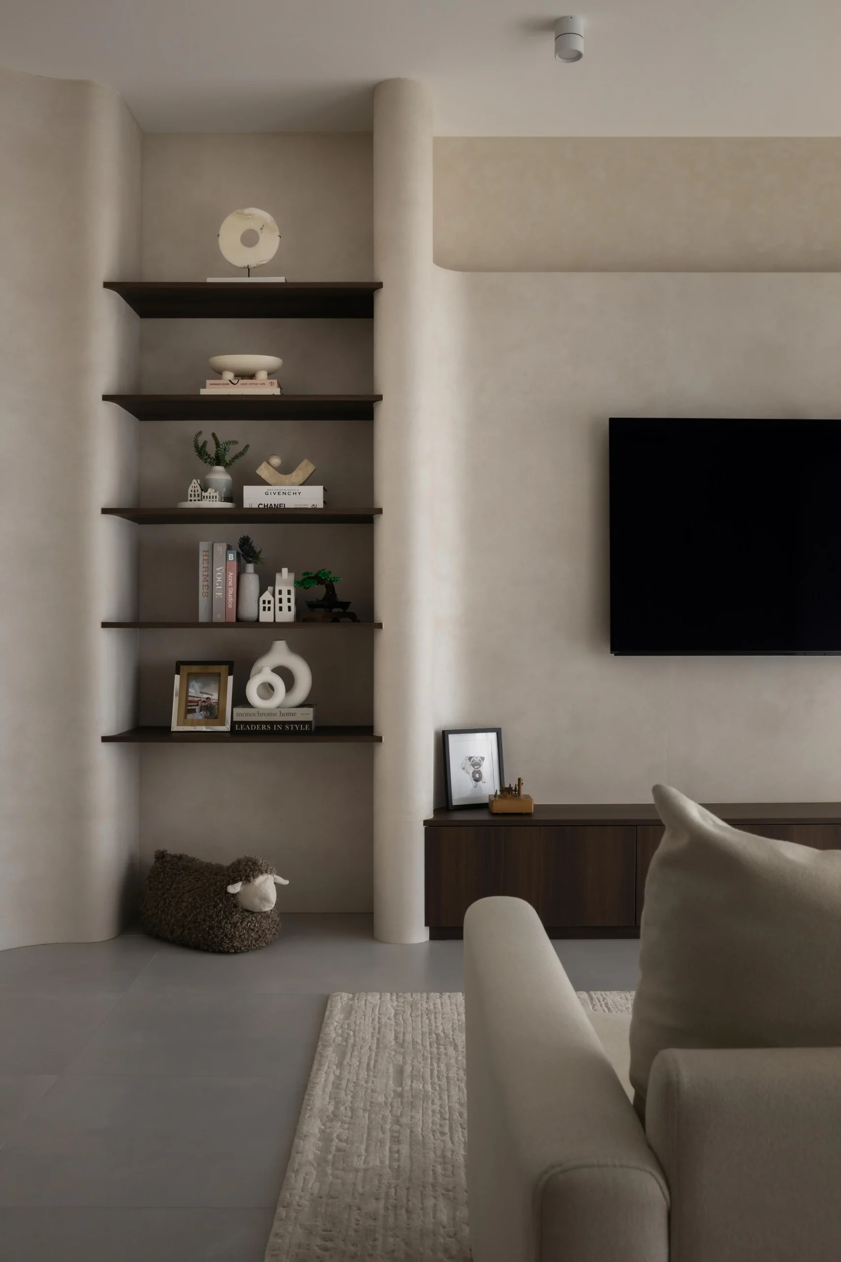 Unlit open shelving integrated into curved walls in a modern japandi home